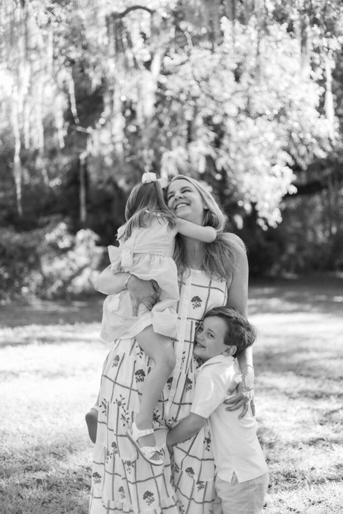 Little girl tightly hugging her mom for their Hilton Head Family Photos, with Lamp & Light Photography.