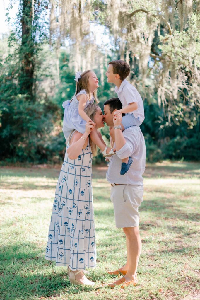 Mom and dad with their kids on their shoulders and kids are laughing with Hilton Head Island Family Photographer, Lamp & Light Photography